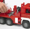 A hand is pouring water into a toy fire truck. Náhled obrázku produktu