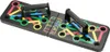 A black foldable push-up board with colored markings and handles, shown from a slightly elevated angle against a white background. Produktbild-Vorschau