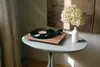 A turntable with a vinyl record on a table, next to a vase of flowers. Anteprima dell’immagine prodotto