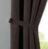A close-up view of a brown curtain held back by a tie-back. Produktbild-Vorschau