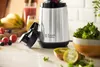 A Russell Hobbs blender is shown on a kitchen counter with fruits and greens, ready to make a smoothie. Náhled obrázku produktu