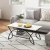 A modern living room scene with a marble-effect coffee table placed on a patterned rug in front of a sofa. Voir les images du produit