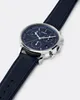 A close-up, angled view of a blue Timex chronograph watch with a navy blue leather strap, set against a plain white background. Podgląd zdjęcia produktu