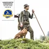 A hunter with his dog in a natural outdoor setting. Anteprima dell’immagine prodotto