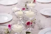 A table setting with floating candles and flowers. Anteprima dell’immagine prodotto