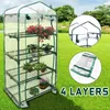 A four-tier mini greenhouse with plants on a grassy lawn, with inset images showing construction details and a folded cover. Náhled obrázku produktu
