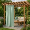 An outdoor living space with a pergola, sofa, coffee table, and a curtain. Podgląd zdjęcia produktu