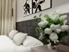 A bedroom scene with a bed, pillows, curtains, artwork, and a vase of flowers. Produktbild-Vorschau