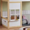 A close-up view of a child's bed frame with a window feature, showing some books and a toy car. Produktbild-Vorschau