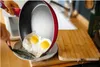 Frying eggs in a pan and transferring them to a plate. Náhled obrázku produktu