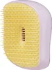 A close-up, studio shot of a lilac and yellow hairbrush. Produktbild-Vorschau