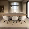 A dining room with an oval table and chairs, set against a backdrop of curtains and a window. Voir les images du produit