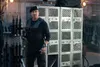 A man in tactical gear stands in front of lockers and weapons. Produktbild-Vorschau