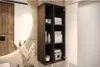 A modern bathroom vanity with a wall-mounted cabinet and a large round mirror. Produktbild-Vorschau