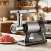 A meat grinder is shown on a kitchen counter with ground meat next to it. Produktbild-Vorschau