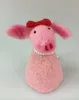A felted pig figurine with a red bow and pearl necklace. Produktbild-Vorschau