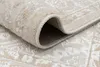 A close-up view of a rolled-up rug, showing its texture and edge. Produktbild-Vorschau