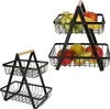 Two black metal fruit baskets with wooden handles are shown against a white background. One is a two-tiered basket filled with various fruits, and the other is a single-tiered basket. Anteprima dell’immagine prodotto