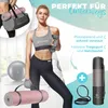 A woman is posing with fitness equipment, including a yoga mat, dumbbell, and a water bottle. Produktbild-Vorschau