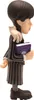 A side view of a Wednesday Addams figurine holding a book. Podgląd zdjęcia produktu