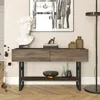 A console table with decorative items and artwork in a room. Náhled obrázku produktu