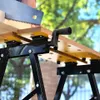 A person is using a saw to cut a piece of wood on a workbench. Náhled obrázku produktu