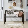 A metal garden bench with a decorative backrest, placed indoors in an entryway with a rug in front of it. Produktbild-Vorschau
