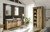 A modern bathroom with a rustic wooden vanity, two sinks, mirrors with LED lighting, a ladder towel rack, and a tall storage cabinet. Produktbild-Vorschau