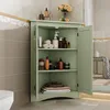 A green corner cabinet filled with toiletries and towels in a bathroom setting. Produktbild-Vorschau