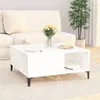 A white coffee table with books and a vase of flowers in a living room setting. Náhled obrázku produktu