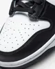 A close-up view of the toe box and side panel of a black and white Nike Dunk High sneaker. Náhled obrázku produktu
