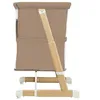Side view of a baby crib/bed with wooden legs and beige fabric. Náhľad obrázku produktu