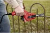 A person is using a Black & Decker power file tool on a rusty metal fence. Náhľad obrázku produktu