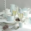 A table setting with tableware and drinks, decorated with pine cones and ornaments. Produktbild-Vorschau