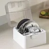 A white storage box with various chopping and slicing attachments for a food processor. Podgląd zdjęcia produktu