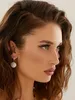Close-up profile shot of a woman wearing earrings. Anteprima dell’immagine prodotto