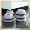 Several anti-vibration pads are stacked on a wet floor, with a washing machine in the background. Podgląd zdjęcia produktu
