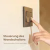A hand is shown pressing a light switch on a wall. Anteprima dell’immagine prodotto