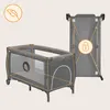 A baby crib/playpen is shown in an unfolded state, with a second image showing it folded and locked. Produktbild-Vorschau