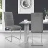 Two dining chairs are shown next to a glass-topped dining table in a modern dining room setting. Produktbild-Vorschau