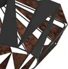 A close-up view of a geometric lamp fixture with black metal framing and wood-like panels. Produktbild-Vorschau