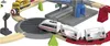 A toy train set with multiple train cars and tracks, including a station. Podgląd zdjęcia produktu