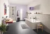 A modern bathroom with a bathtub, shower, sink, and toilet. Voir les images du produit