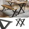A dining table and bench set with X-shaped legs on a patterned rug. Anteprima dell’immagine prodotto
