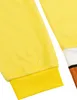 Close-up of a yellow fuzzy fabric with a ribbed yellow cuff, and a hint of white, brown, and black fabric on the right side. Produktbild-Vorschau