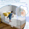 A child climbing over a bed guardrail on a bed. Voir les images du produit