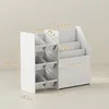 A white children's storage unit with multiple bins and shelves, shown with dimensions indicated by text overlays. Produktbild-Vorschau