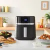 A kitchen counter with an air fryer and food. Produktbild-Vorschau