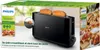 The image shows the packaging of a Philips toaster, with the toaster itself prominently displayed and some food items featured on the side. Produktbild-Vorschau