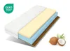 A cross-section of a mattress showing its different layers, with coconuts and palm leaves in the foreground. Produktbild-Vorschau